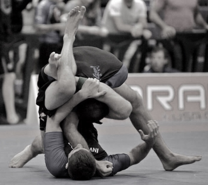 Adults training Brazilian Jiu Jitsu in a competition setting