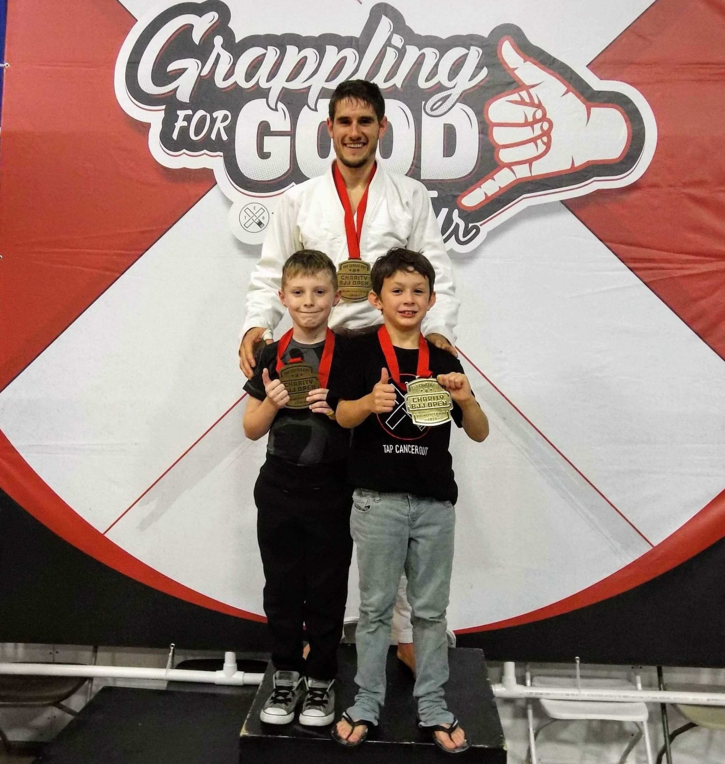Youth Jiu Jitsu students with medals