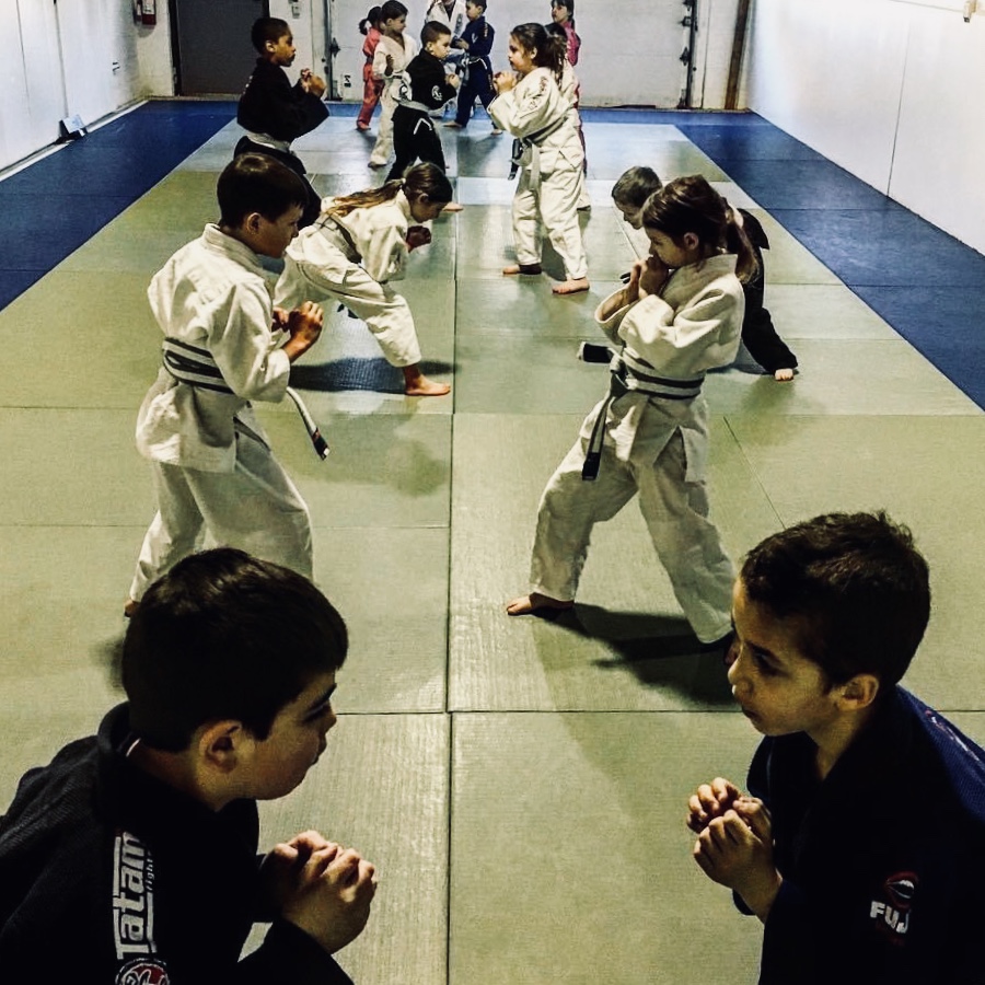 Children practicing Jiu Jitsu on the mats at Achieve Jiu Jitsu Academy